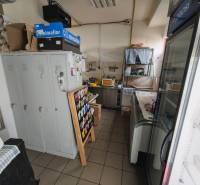 Space of a gastro establishment with storage cabinets and cooling showcases.