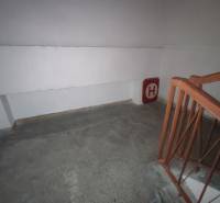 Interior of the staircase in the Office, with a railing and fire hydrant signage on the wall.