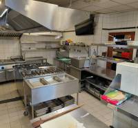 Kitchen gastro spaces with stainless steel equipment and tiled floor.
