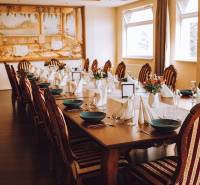 A table set for a feast, a floor with a wooden decor, a decorative wall mural.
