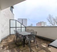 Terrace with garden furniture in a 2-room apartment, view of the apartment buildings Bratislava - Vajnory, Rybničná.