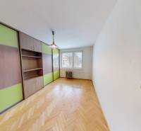 A room with a wooden decor floor, built-in wardrobe. 3-room apartment with storage space.