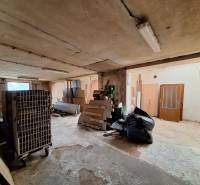 Warehouses and halls with various construction waste and equipment, including old doors.