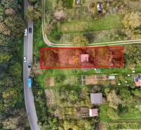 Aerial view of a garden cottage in Hlohovec surrounded by greenery and a road.