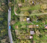 Aerial view of garden cottages near the forest in Hlohovec with a road.