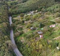 The area near Hlohovec with numerous cottages and a forest along the road.