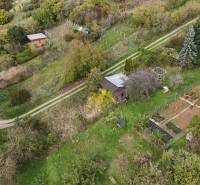 An aerial view of cottages surrounded by gardens and greenery in Hlohovec.