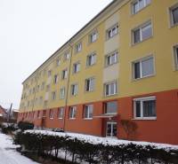 The building on 17. novembra Street in Prešov with a colorful facade and snowy surroundings.