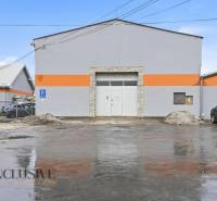 The building of commercial premises on Pod kalváriou Street in Topoľčany with parked cars.