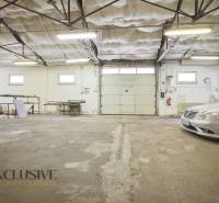 Space with a garage door and stored materials, commercial premises.