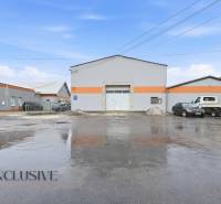 The exterior of commercial premises on Pod kalváriou Street in Topoľčany with parked cars.