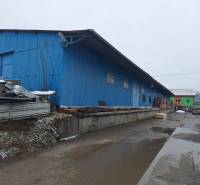 Blue warehouse buildings on Lieskovská Road in Zvolen, surrounded by various materials.