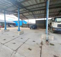 Garages on Lieskovská Road in Zvolen with concrete surfaces and parked vehicles.
