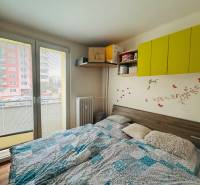Bedroom with wall decorations in a 3-room apartment, floor with wood decor.