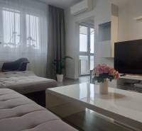 Living room with a comfortable sofa and a large window, 2-room apartment.