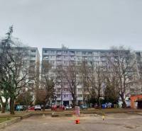 Apartment building on Šalviova Street in Bratislava-Ružinov with a children's playground and parked cars.