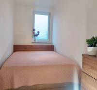 Bedroom with a comfortable bed and decorations in a 2-room apartment.