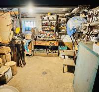 Workshop in a family house with tools, wood, and a workbench.