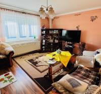 Living room in a family house with floral decorations and wooden decor flooring.