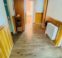 Interior of a family house with a wooden decor floor and wooden wall paneling.
