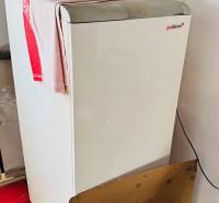 A boiler in a family house with a sand container and tools.