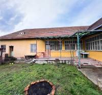 A family house in Komjatice with a garden, terrace, and wooden shelter.