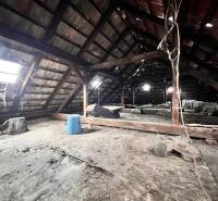 The attic of a family house with a wooden structure and roof windows in Komjatice.