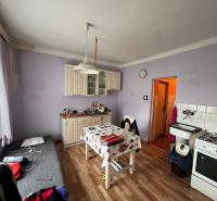 A kitchen in a family house with a wooden decor floor and furniture.