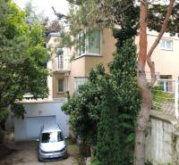 A family house on Malinová Street in Bratislava - Staré Mesto surrounded by greenery and trees.