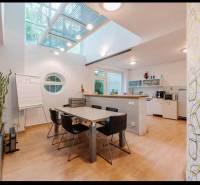 Interior of a family house with a dining table, round window, and floor with wood decor.