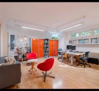 Interior of a family house with an office area, wooden decor flooring, orange cabinets.