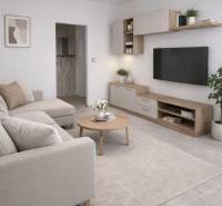 Living room with a sofa, table, TV, and decorations in a 3-room apartment.