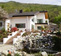 A family house in Hainburg an der Donau with a well-maintained garden and stone landscaping.