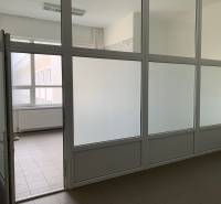 Offices with partition walls, surrounded by glass surfaces, simple design.