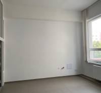 Interior office with large windows and light walls.