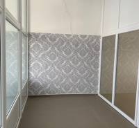 Offices with decorative wallpaper and glass partitions, tiled flooring.