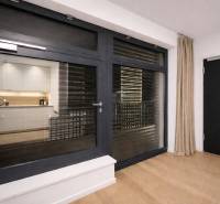 1-bedroom apartment with wood-patterned flooring, large window, and curtains.