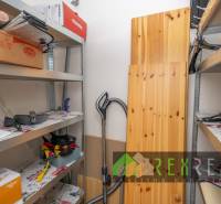 Storage space with metal shelves and various items in a 3-room apartment.