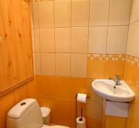 Bathroom with a toilet and a sink in a 3-room apartment.