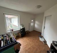 The entrance hall in the family house with a wooden decor floor adjoins the vestibule.