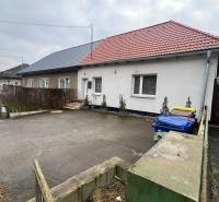 A family house on Osloboditeľov Street in Lieskovec with two colored roofs and containers.