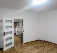 Interior of a family house with white walls and a floor with a wood decor.