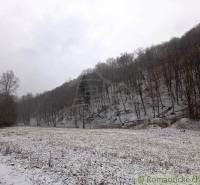 A snowy meadow surrounded by forests in the winter landscape of Hrušov in Záhrady.