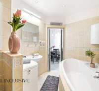 Bathroom in a 3-room apartment with a bathtub, sink, and decorations.