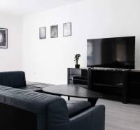 Living room with a corner sofa and a television in a 2-room apartment.