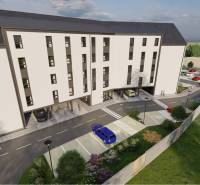 Commercial land on Moravská Street in Vráble with a parking lot and a modern building.