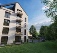 A building with balconies on Moravská Street in Vráble, surrounded by greenery, Commercial land.
