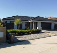 A family house in Banská Bystrica with a garden and a paved driveway.