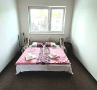 Bedroom in a 3-room apartment with a bed, a window, and towels placed on the decor.