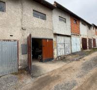 Garages on Prachatická Street in Zvolen with various types of doors and facades.